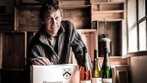 Small to Mid Size Business man in shed with wine bottles