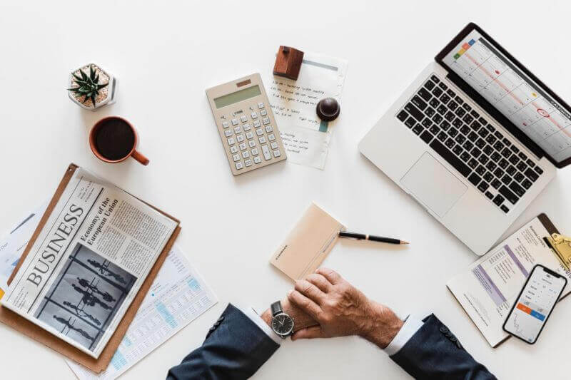 Man sat at desk surrounded by laptop and paper swindells east sussex accounting