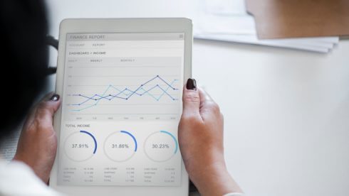 Man looking at ipad tablet doing financial research