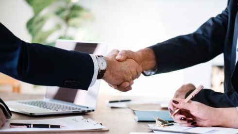 Two men shaking hands small business exit swindells planning