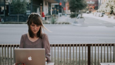 woman sat at a laptop at a cafe swindells east sussex freelancer tax and accounting