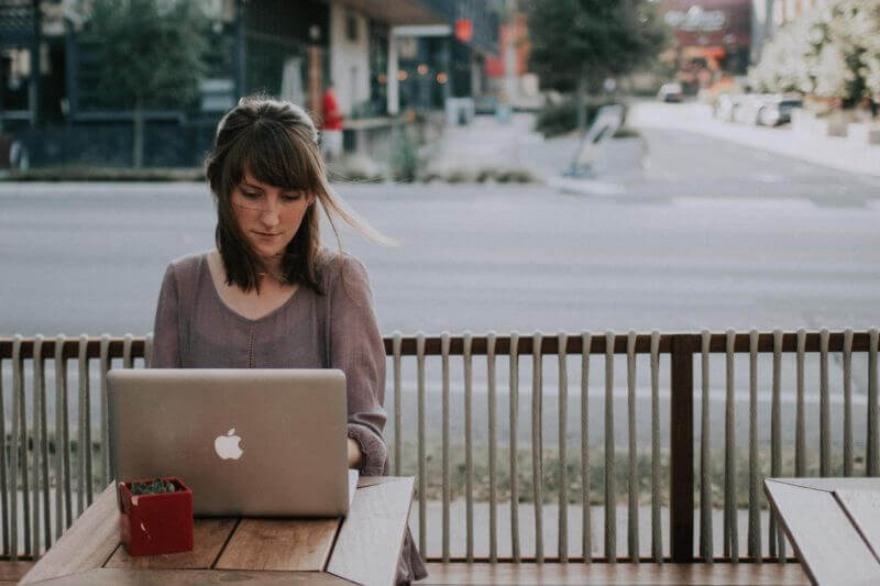 woman sat at a laptop at a cafe swindells east sussex freelancer tax and accounting