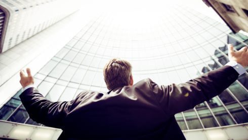 Man standinf in front of buildings
